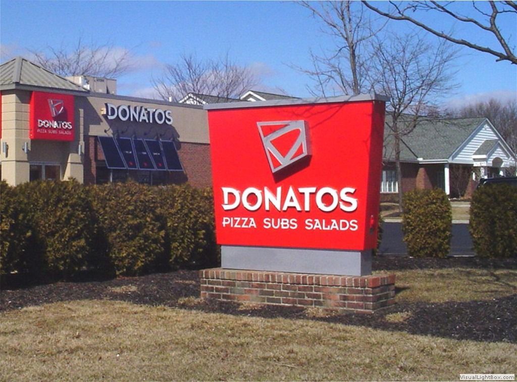 Donatos restaurant with red sign and logo, outside. Red sign with text: 