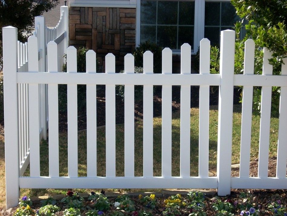 White picket fence in front of a house.