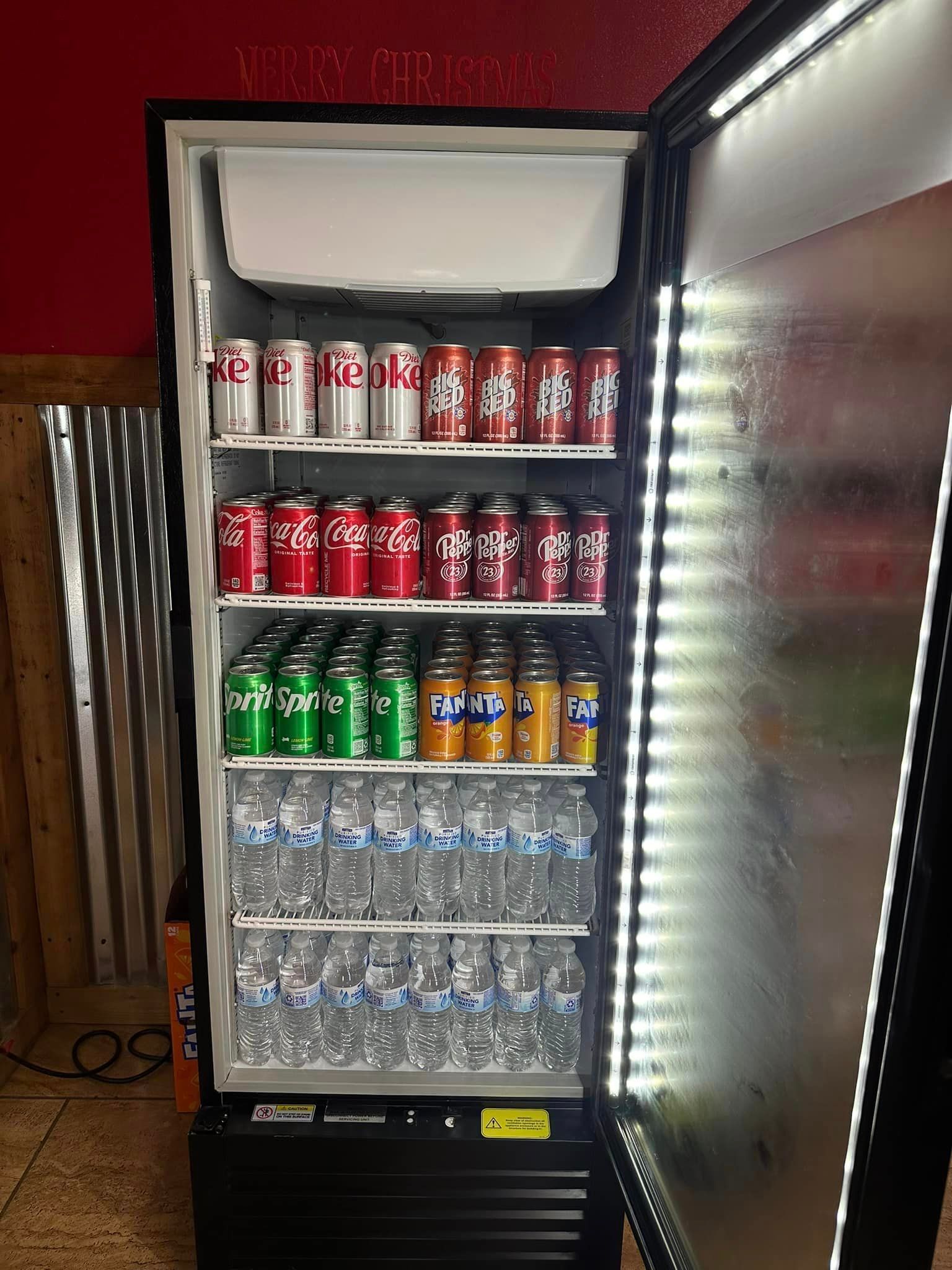 A refrigerator filled with sodas and water bottles