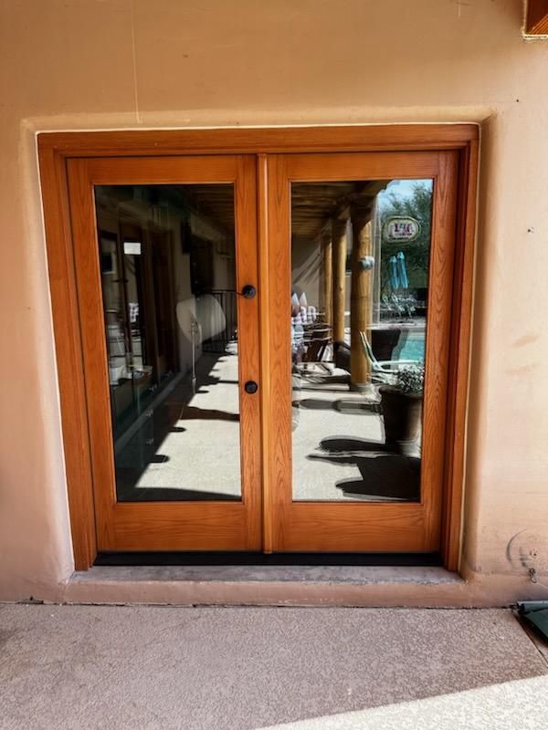 A wooden door with a reflection of a pool in it