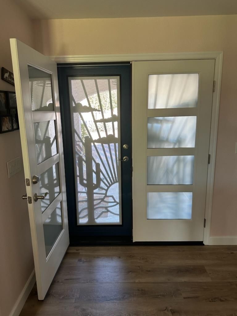 A door with a design on it is open in a room.
