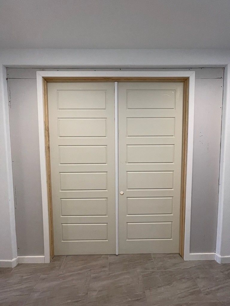 A pair of white sliding doors in a room.