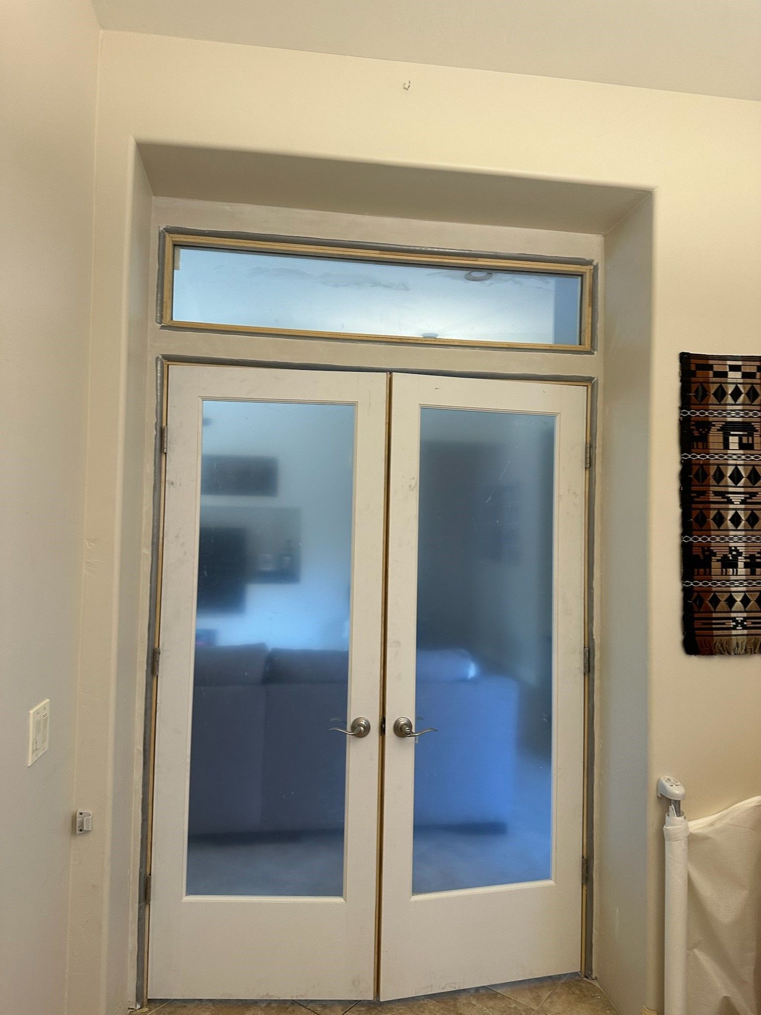 A pair of white sliding glass doors in a room.