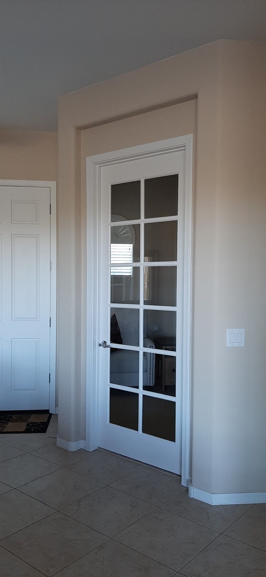 There is a french door in the corner of the room.