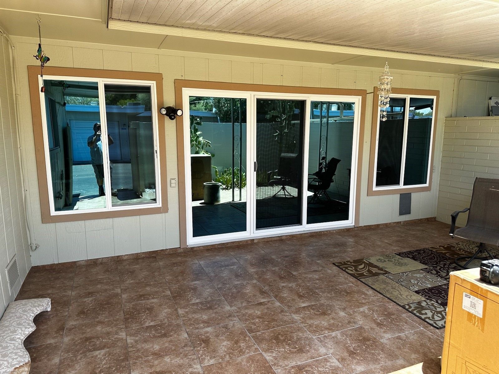 A patio with a lot of windows and sliding glass doors