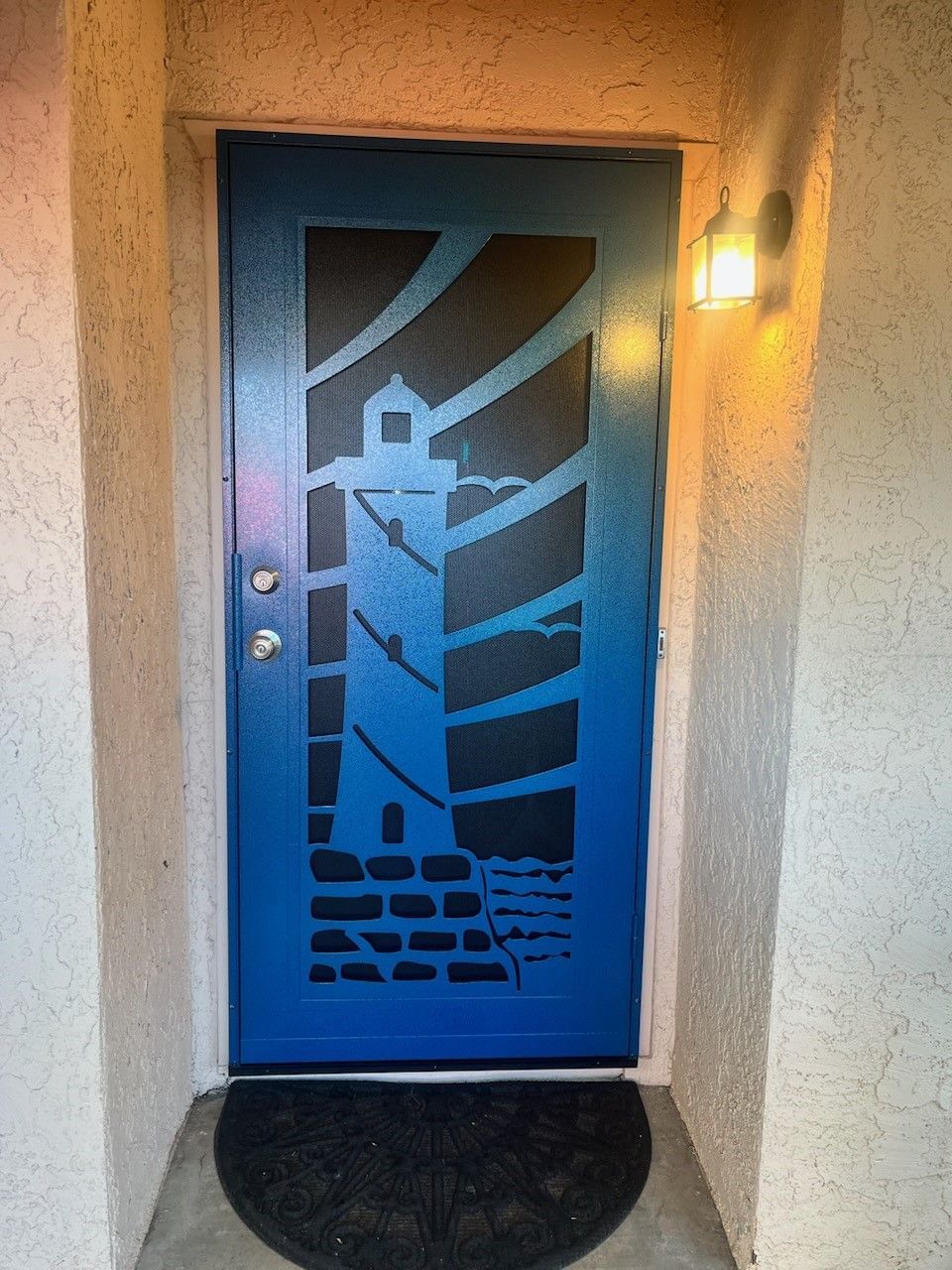 A blue door with a lighthouse design on it