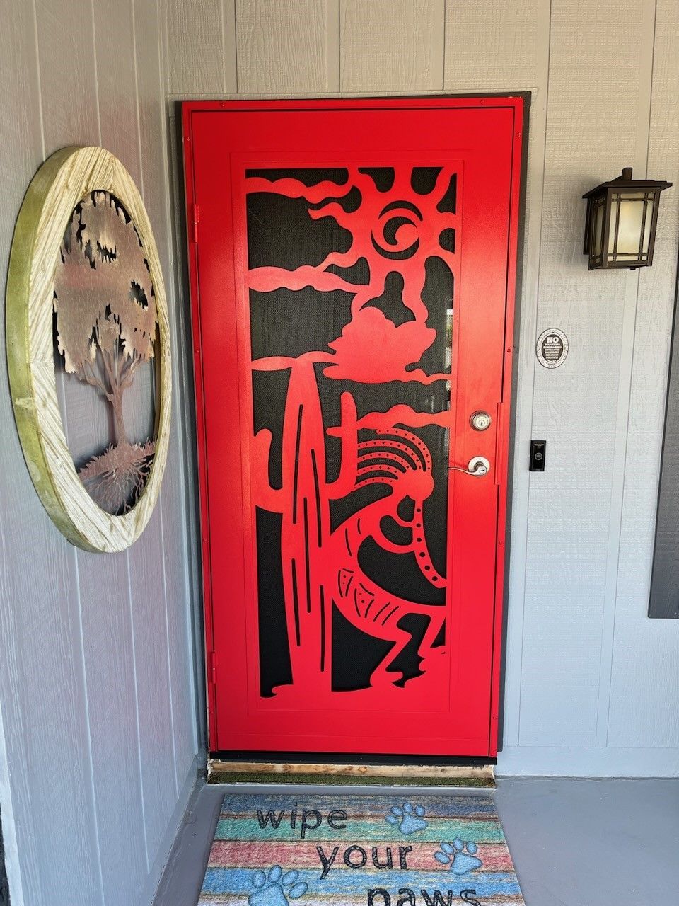A red door with a black design on it