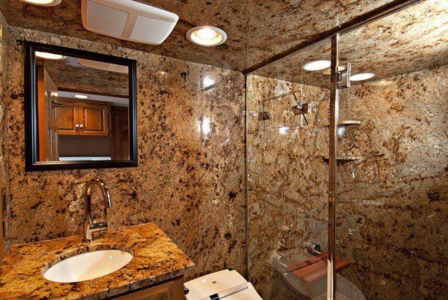 A bathroom with a sink , toilet and shower.