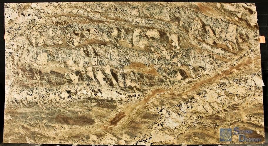 A close up of a piece of granite on a black surface.