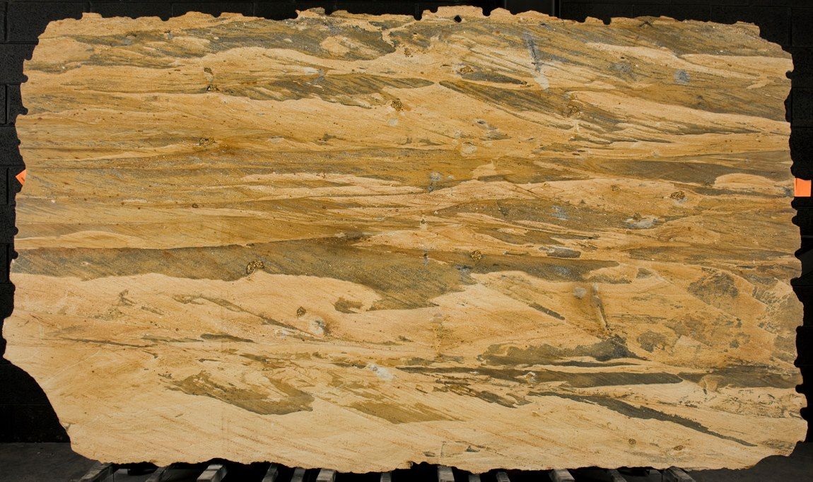 A piece of wood is sitting on a table with a black background.