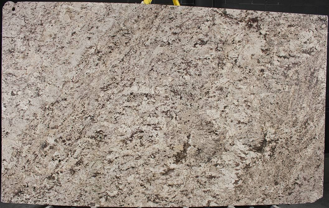 A close up of a piece of granite on a black surface.