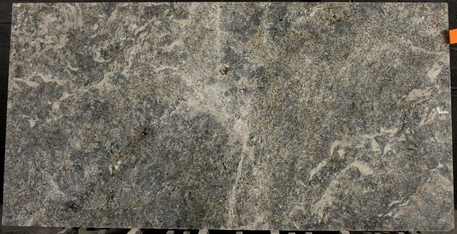 A close up of a gray granite slab on a table.