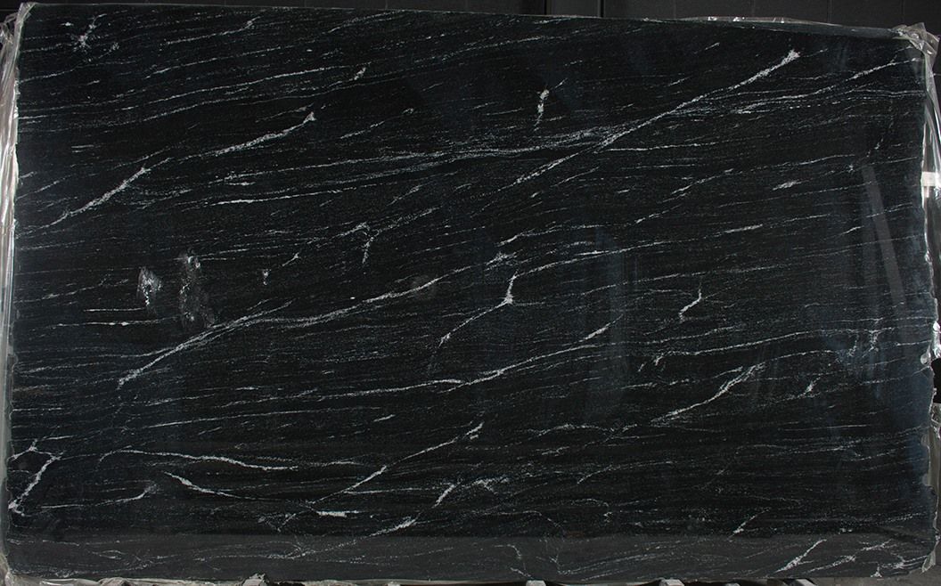 A close up of a black block of soap