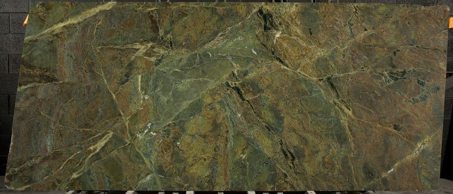 A green marble slab is sitting on top of a wooden table.