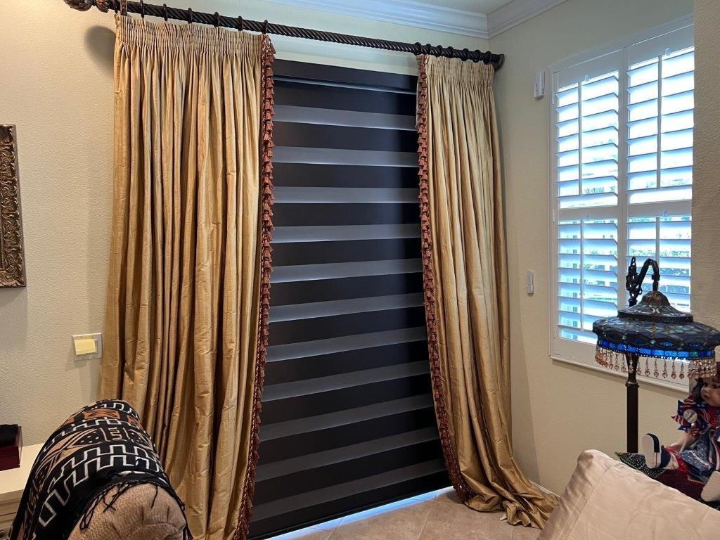 A living room with striped curtains and shutters