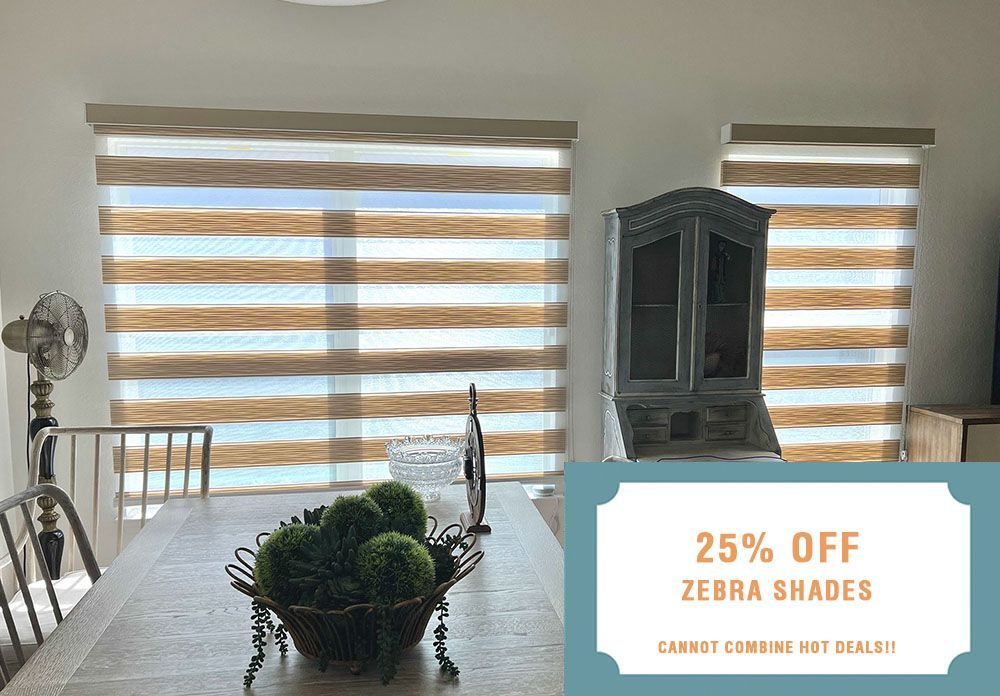 A dining room with a table and chairs and zebra shades on the windows.