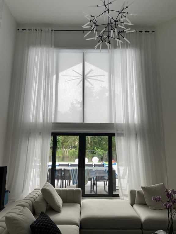 A living room with a couch and a large window