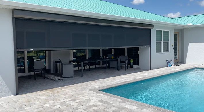 There is a swimming pool in the backyard of a house.