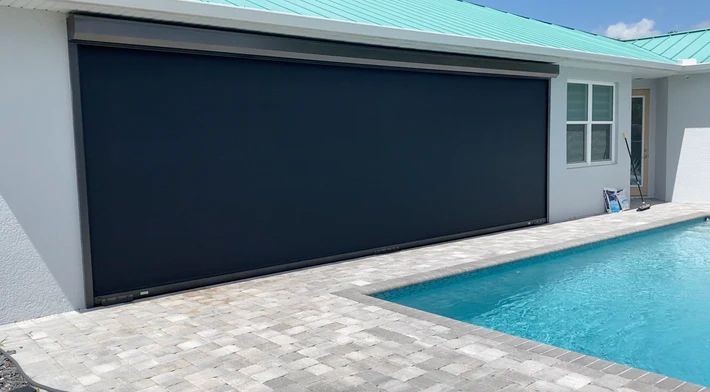 A house with a swimming pool in front of it.