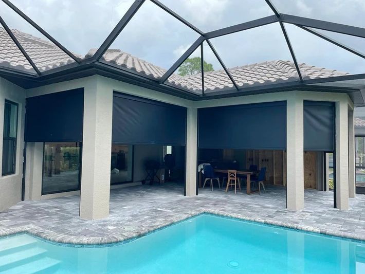 A house with a swimming pool and a screened in porch.