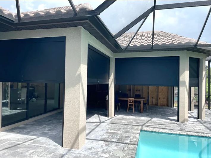 There is a swimming pool in the backyard of a house.