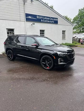 Black Chevrolet SUV parked in front of a white building with 