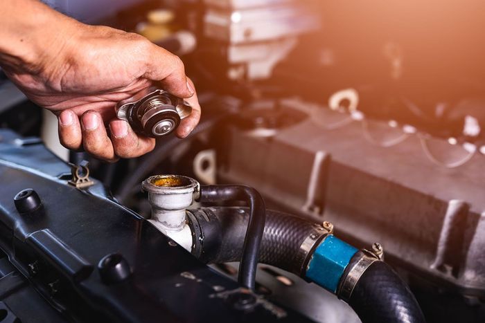 A mechanic checking a car's radiator