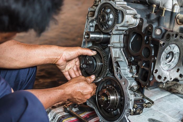 a man is working on a car engine in a garage