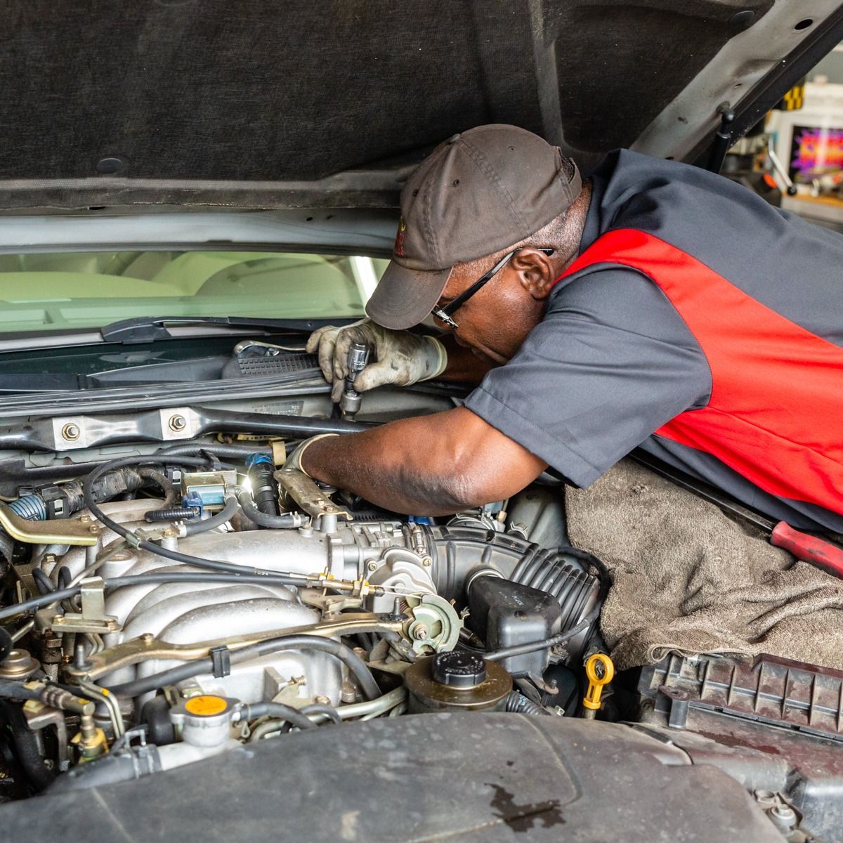 a man is working under the hood of a car