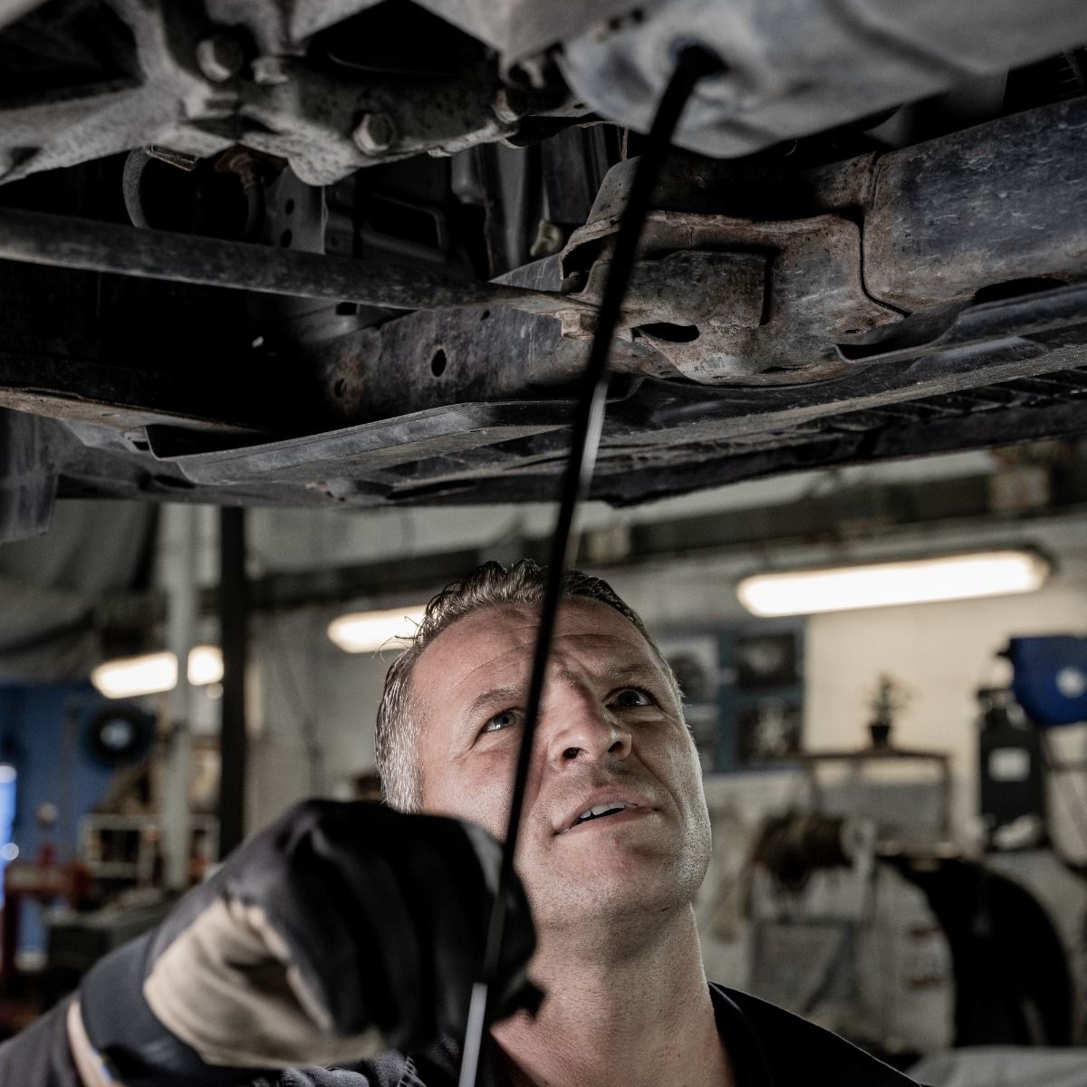 a man is working under a car with a wrench