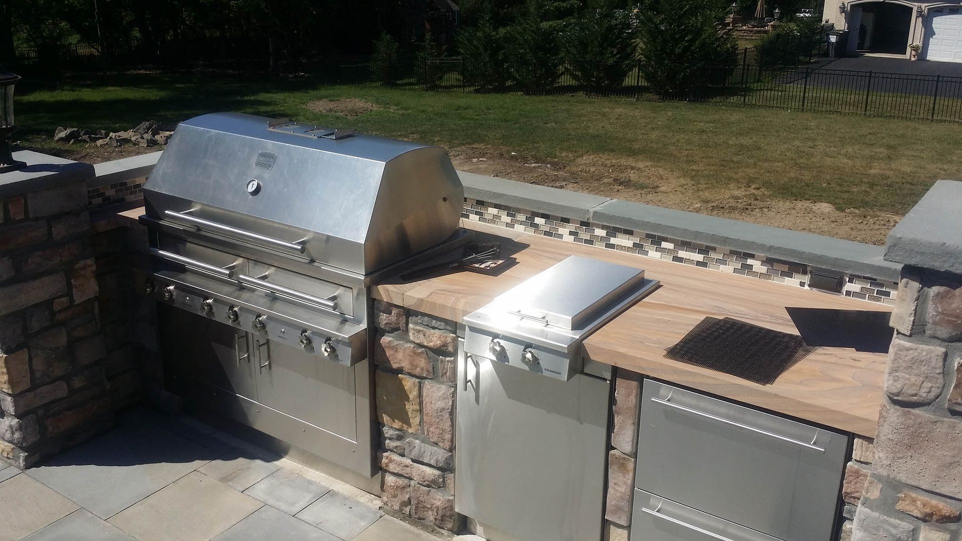 A stainless steel grill is sitting on top of a wooden counter