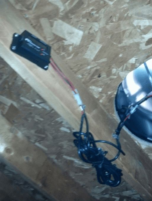 A bunch of wires are hanging from a ceiling