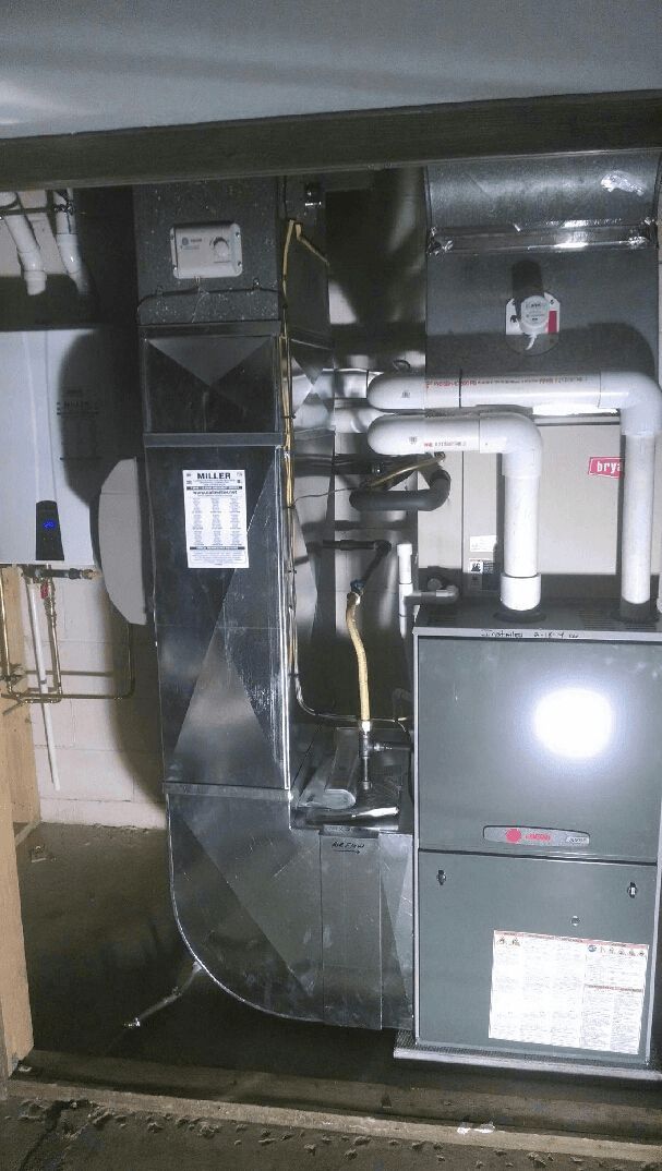 A picture of a heating and cooling system in a garage.