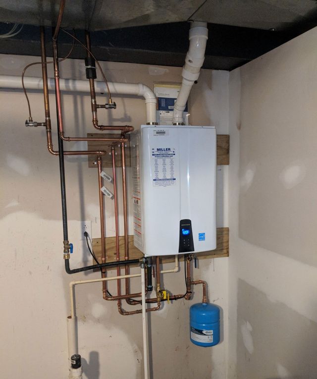 A white water heater with copper pipes attached to it
