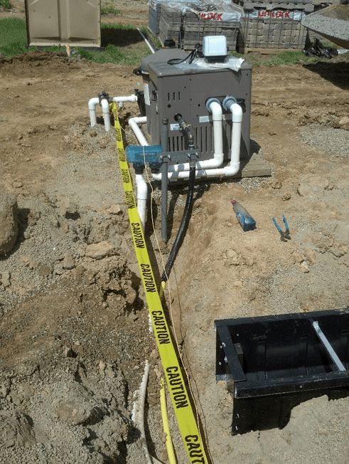 A caution tape is laying on the ground around a machine