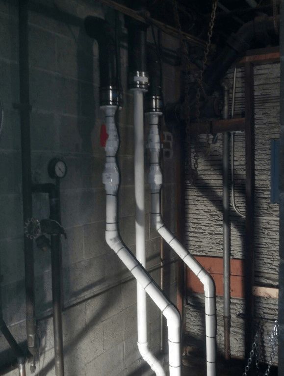 A bunch of pipes are connected to each other in a dark room