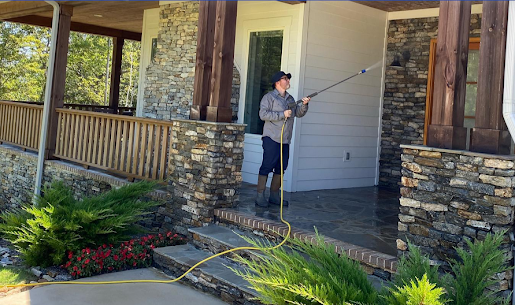 QualityPRO Power Washing expert working on a residential property