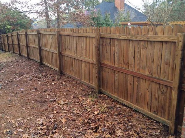 A forklift is parked in front of two large white tanks.