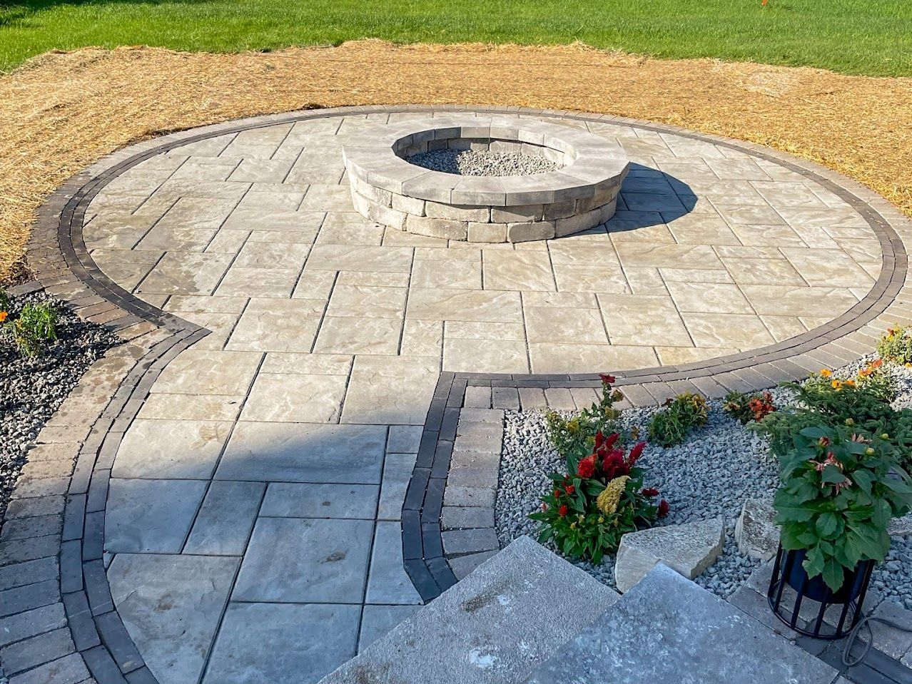 There is a fire pit in the middle of the patio.