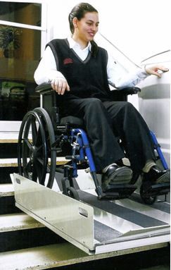 a woman in a wheelchair is using a ramp to get up the stairs