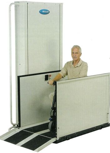 a man in a wheelchair is sitting on a lift