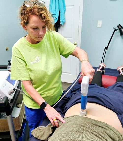 a woman is working on overhead reach