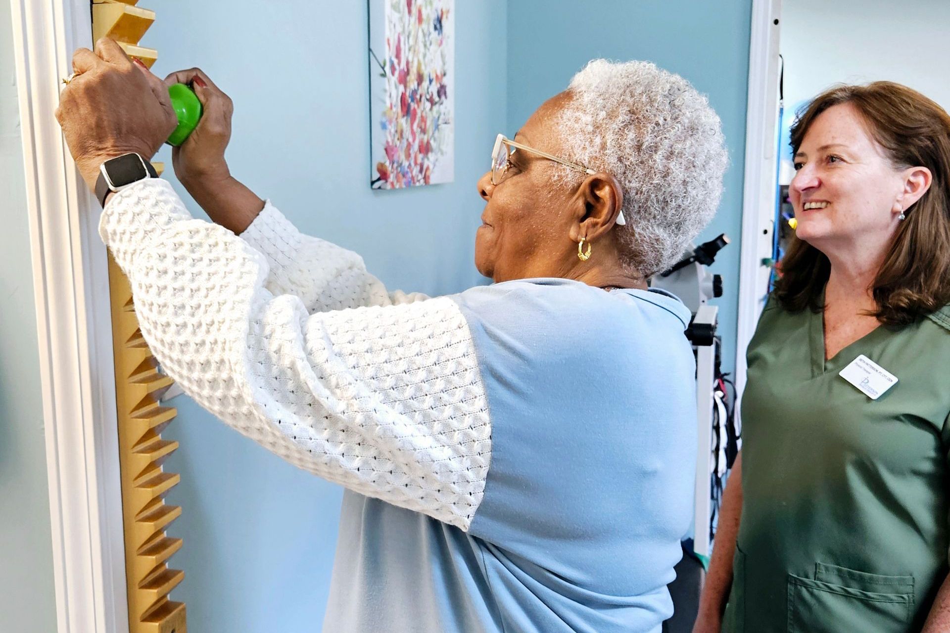 a woman is working on overhead reach