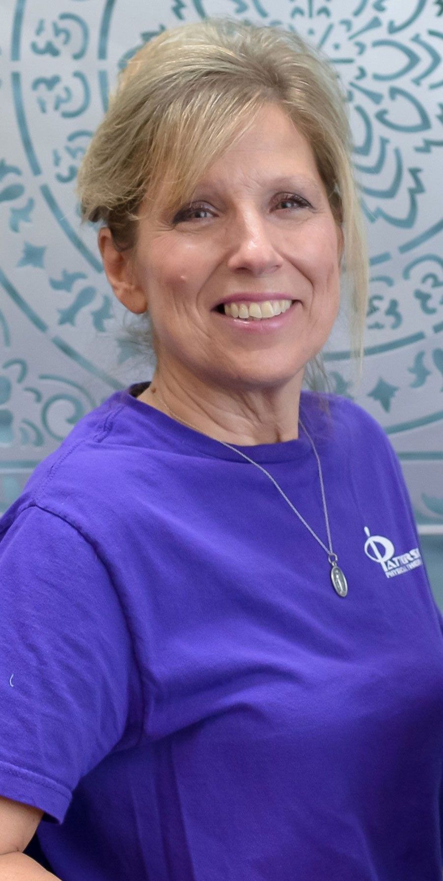 A woman wearing a purple shirt