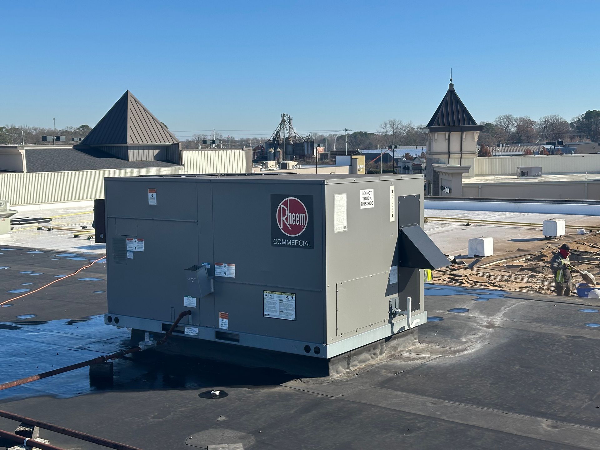 A large gray box is sitting on top of a roof.