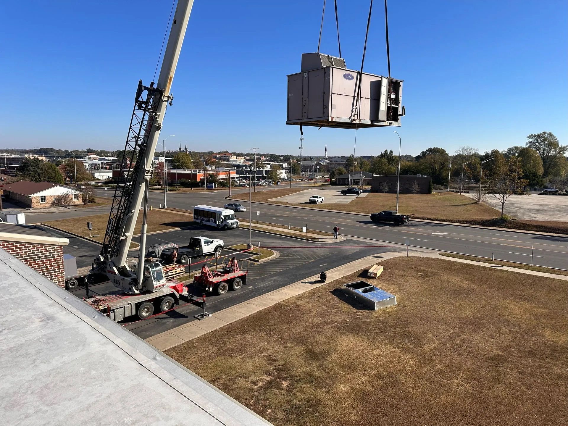 A large piece of equipment is being lifted by a crane.