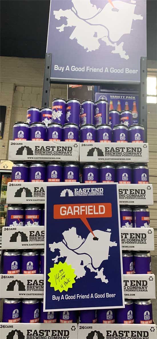 A display of cans of garfield beer in a store
