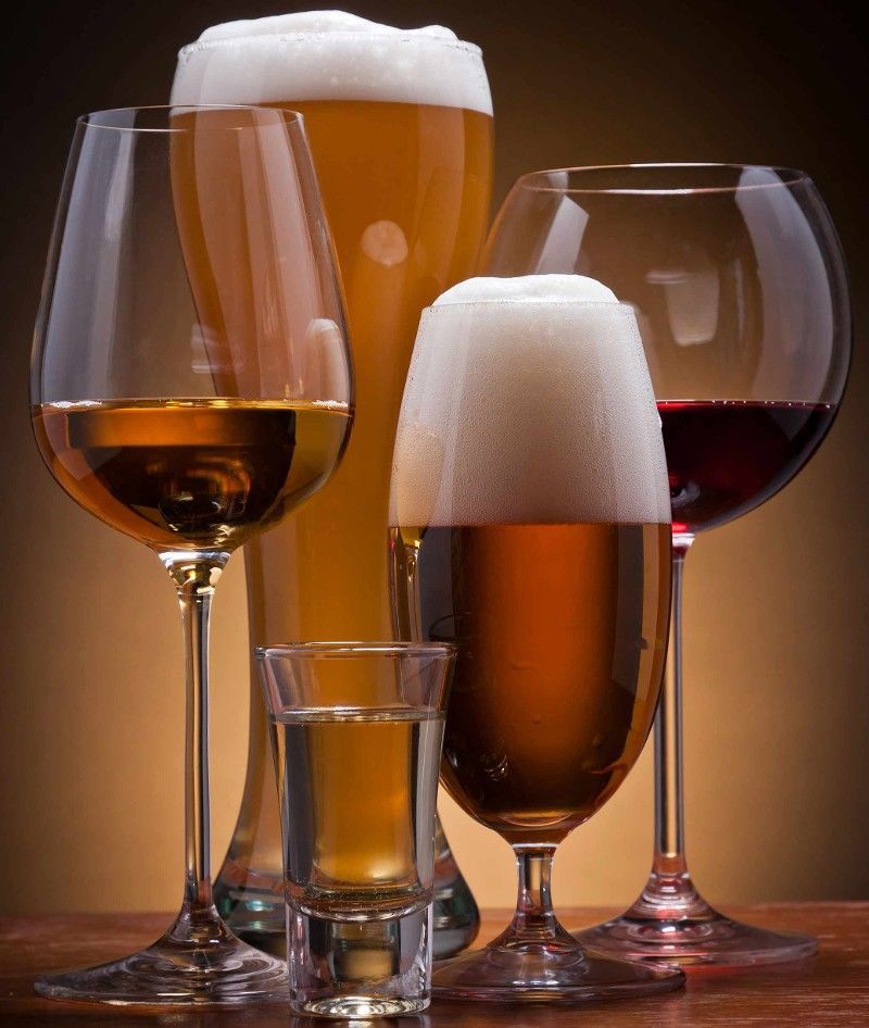 Four glasses of beer and wine on a table