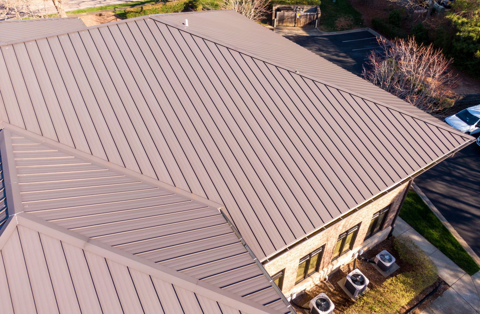 Brown metal roof on a building with multiple angles, seen from above.