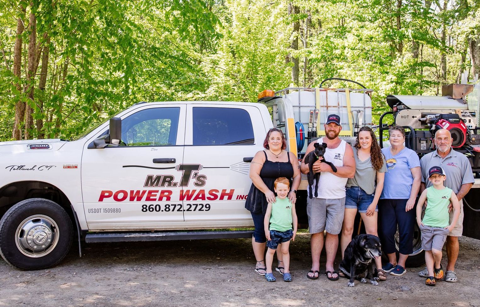 Family members gathered beside service truck